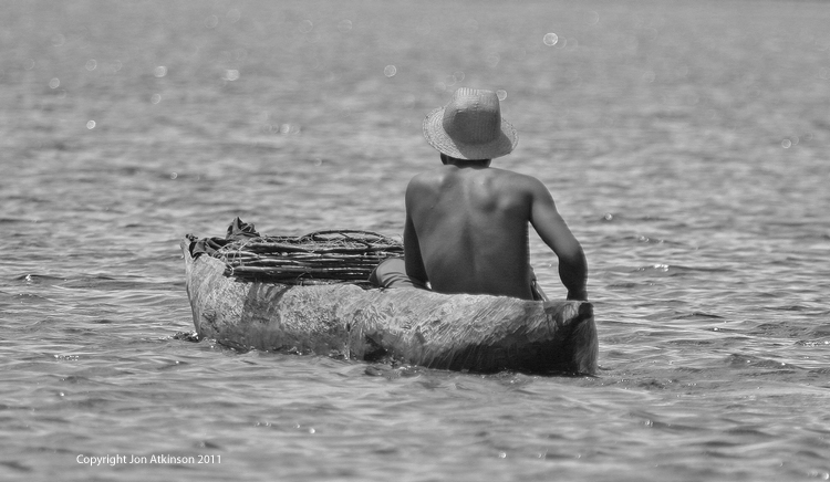 Man in Dug Out Canoe, Tanzania Man in Dug Out Canoe, Tanzania.